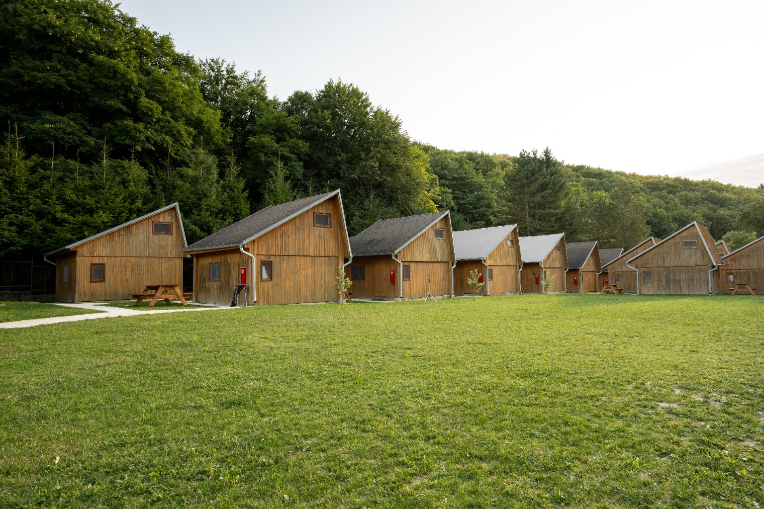 A row of wooden cottages at Cabin Retreat Piešťany