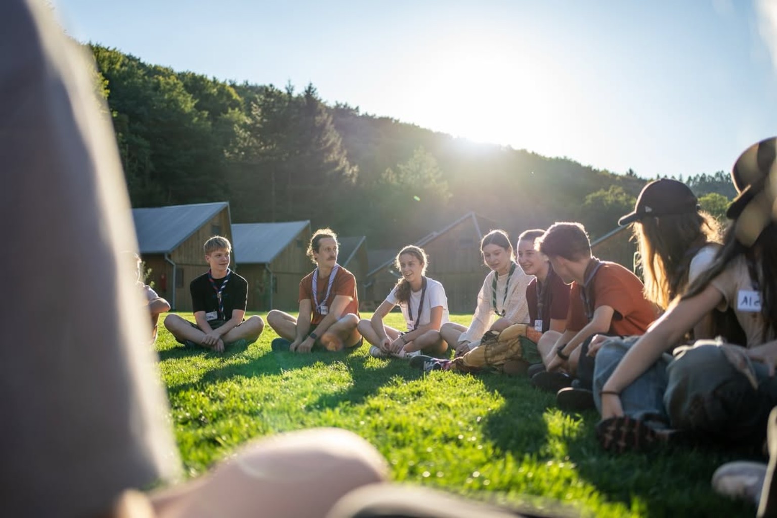 A group sitting together on the grass at Cabin Retreat Piešťany